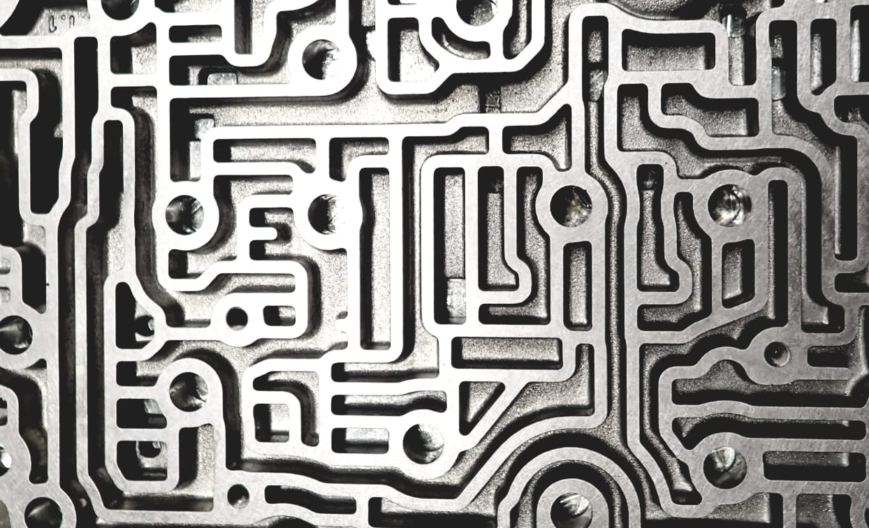 Automatic transmission valve body — channels reflecting service workflow